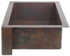 Side view of copper farmhouse sink with 3.5" apron return in dark copper