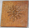 Hammered copper tile with infinity sun design