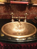 Oval bath sink with custom fox in weathered brass