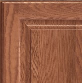 Corner of a KraftMaid cabinet door showing Oak wood in Ginger finish