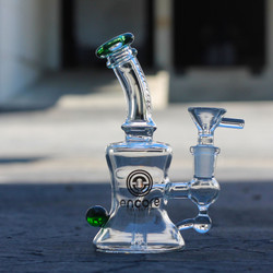 6" Glass Hourglass Dab Rig by Encore Collection sitting on the floor shown with a bowl