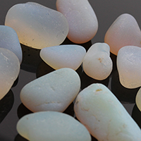 pieces of opalized sea glass on black