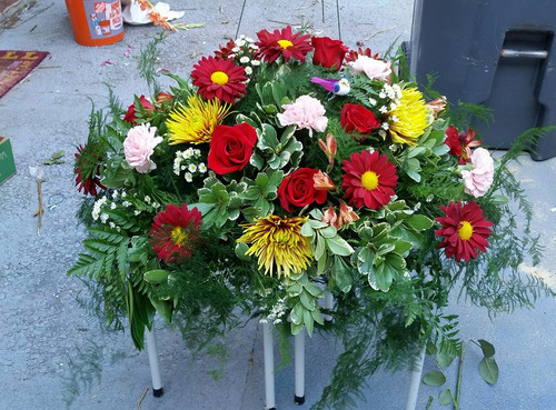 Designers Choice Casket Spray, Multitude of Colors and Flowers in many colors. Flowers could consist of Lilies, Roses, Mums, Sunflowers, Daisies, Carnations. Will always have at least 6 types of flowers. 