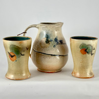 Stunning handmade Pitcher and Tumblers by Phoenix Pottery. These unique one of a kind pieces are special. The hand painted bird over the sun is wonderful. The pitcher and tumblers are functional as well as decorative.  The tumblers are pretty themselves and you can enjoy a nice cold drink like ice tea! 


