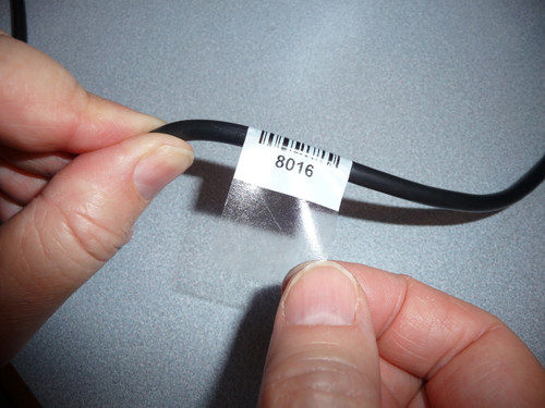 Cable label with clear overlay that wraps around label.