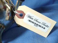 Manila tag on a tea pot with large Adhesive Inventory Label