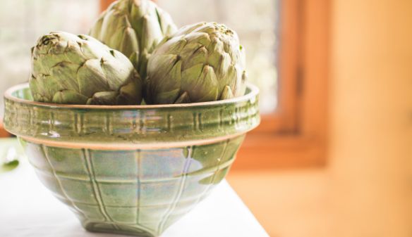 Vintage green stoneware bowl with artichokes