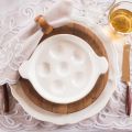 Vintage place setting, escargot plate on wood plate and creamware plate