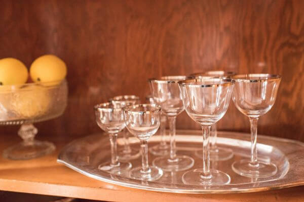 Vintage champagne coupes with silver rims on vintage silver tray
