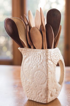 Vintage wood spoon in vintage creamware textured pitcher