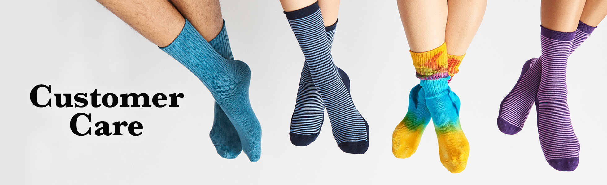 Four legs wearing socks. From left to right the first pair of socks are Denim Blue Crew, then Blue striped dress socks, Colorful Tie Dye Crew socks, and finally purple striped dress socks. Text next to the four legs reads: Customer Care.