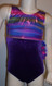 Adorable gymnastics leotard in a multi-colored purple metallic spandex split with purple sparkle velvet.  Available in tank or racer back.  Free scrunchie included as always.