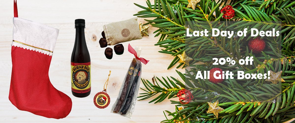 On left, wood background with red and white stocking, bottle of Bowser Beer, ornament, bag of coal cookies, and clear bag with two Doggie Sausage Cigars. On right, tree branches with red and gold ornaments with white text reading "Last Day of Deals. 20% o