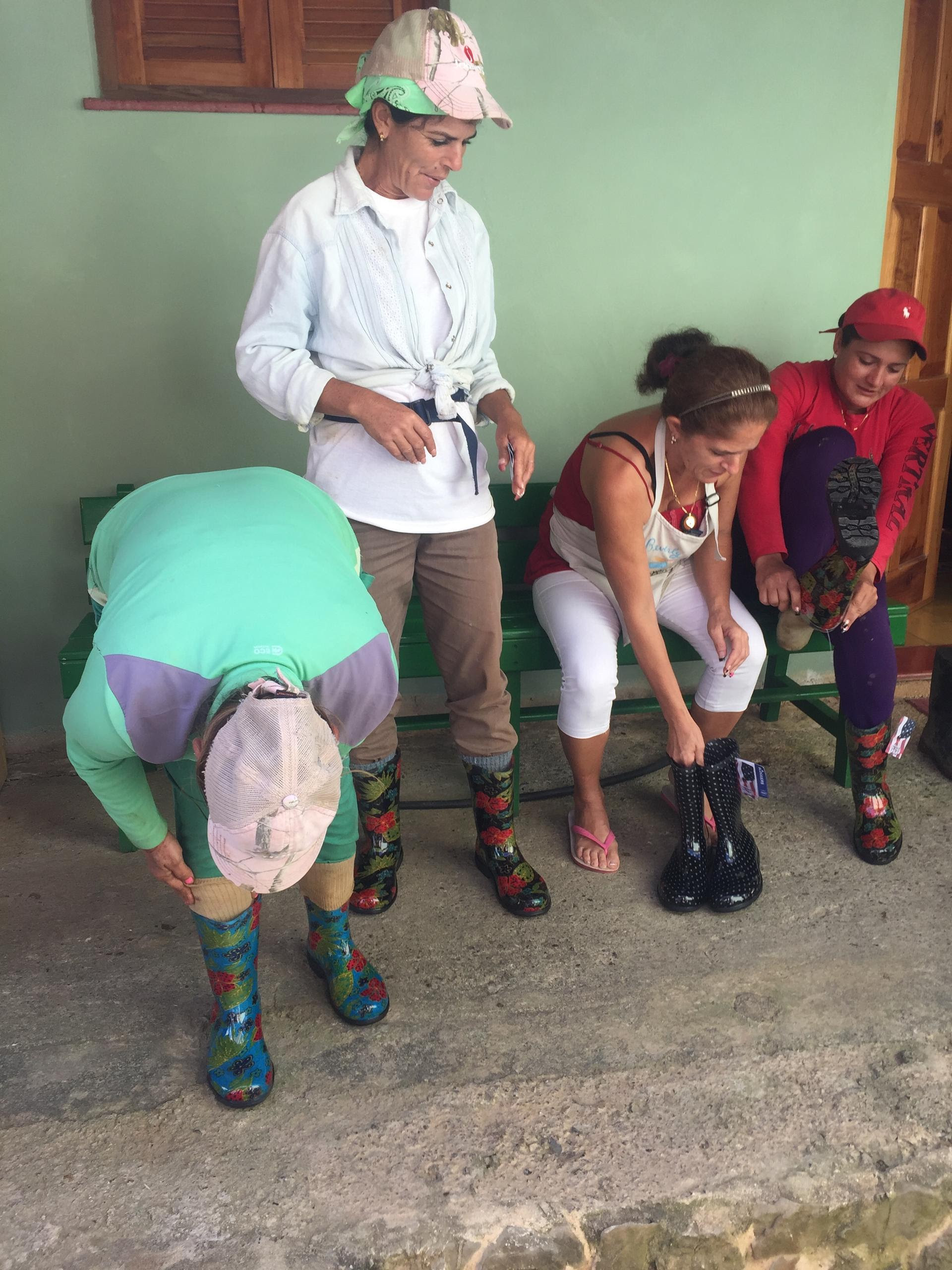 finca-marta-workers-trying-on-boots-donated-by-ccs-members.jpg