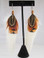 Feather Earrings 5 inch White Saddle and Ring-necked Pheasant Almonds Topping

This original feather earring design is a Tony Hill specialty. The longer feathers are five natural white saddle or schlappen on each earring. The three topping feathers are layered ring-necked pheasant gold sides with a top feather of brown almond.