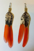 Pair of handmade feather earrings laid flat on a white background,