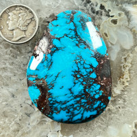 A 118 cts. Giant Bisbee Turquoise cabochon.