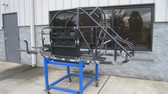 Repaired, Unpainted Chassis  Sitting In Front Of Parts Department