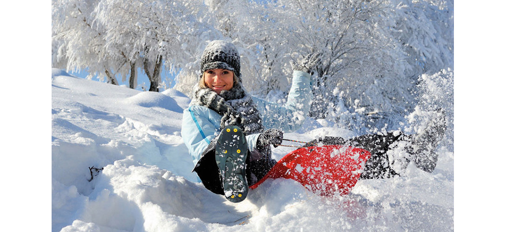 Girl wearing ice cleats in snow