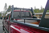 Wildcatter Super Heavy Duty Truck Ladder Rack in black powder coat with standard mesh cab guard, allowing it to carry 2,200 lbs. of evenly distributed loads. Photo credit to Bill Westphall. Toolbox NOT included.