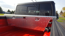 Diamond Plate Aluminum Jeep Gladiator Narrow Low Profile Crossover Toolbox is available in brute aluminum or black powder coat finishes.
