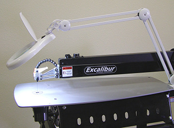 PIVOTING ARM LED MAGNIFIER WORKLIGHT. Provides a bright near natural light with 3X magnification. The long pivoting adjustable arm allows perfect positioning for good illumination and magnification. Has an extra large 5" diameter 3 diopter distortion free magnifier glass and 60 bright long life LED's. Natural type lighting and a handy flip up dust cover for the lense when not in use.