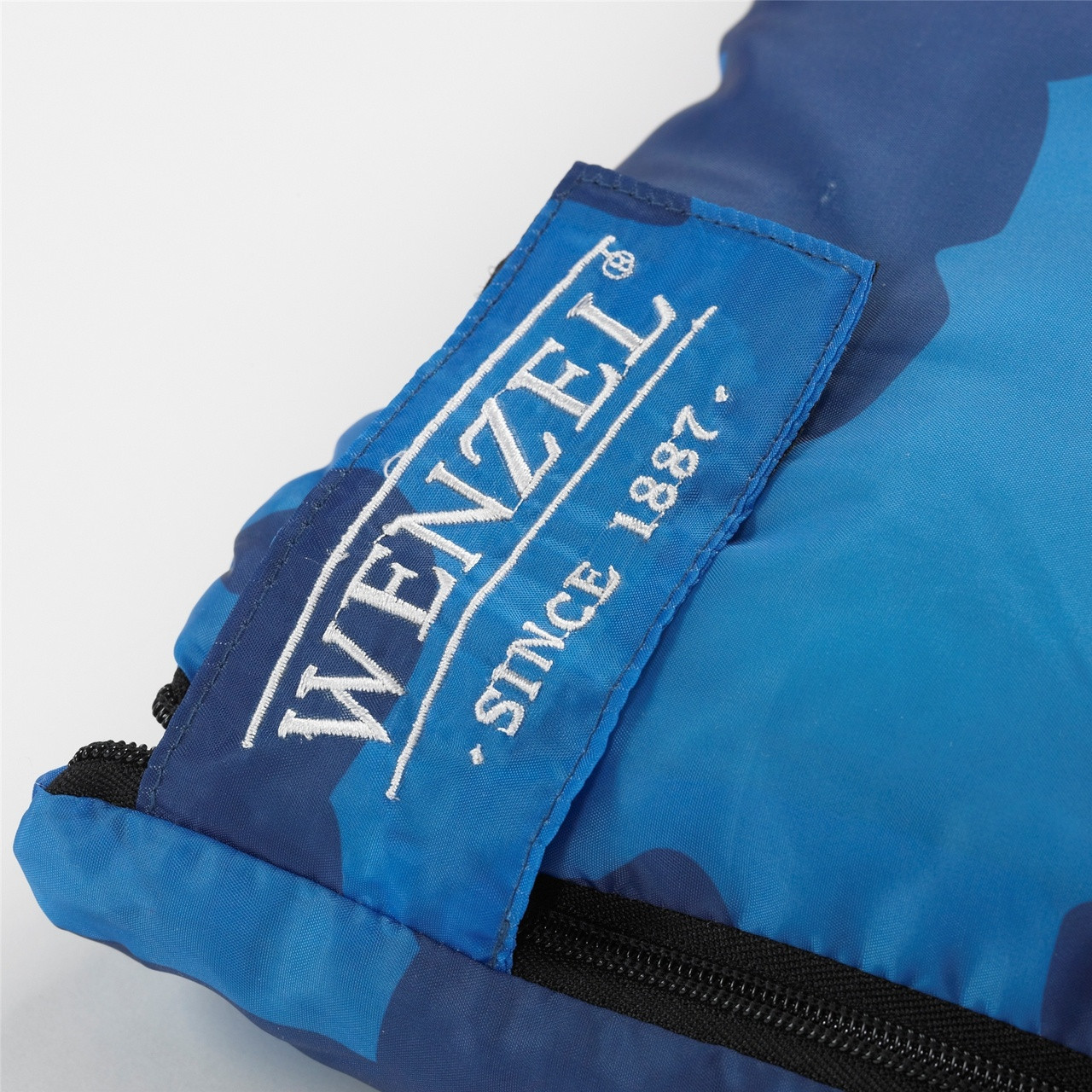 Close up view of the Velcro latch over the zipper on the Wenzel Kids Blue Moose 40 degree sleeping bag
