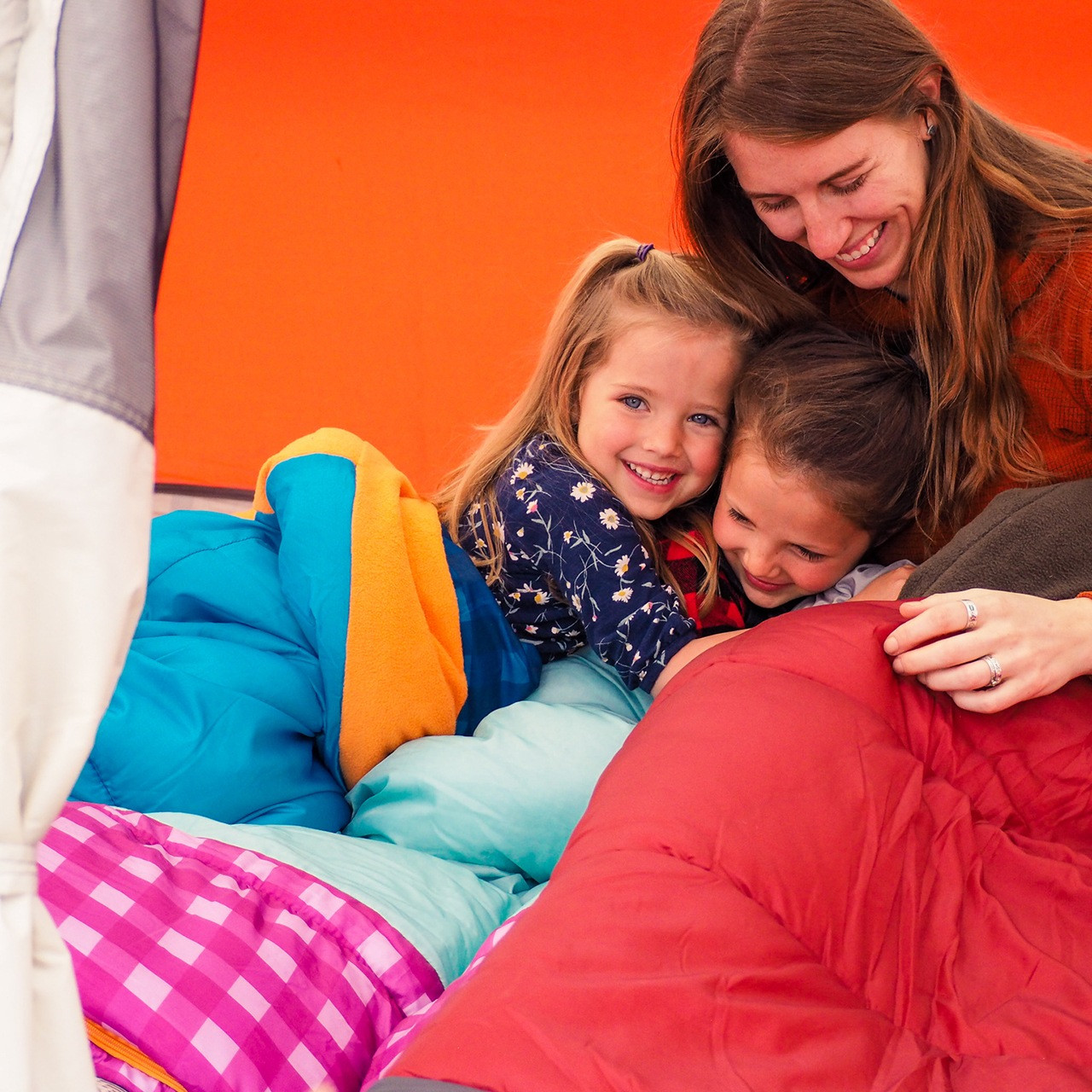 Family with Wenzel Sapling Youth Sleeping Bag, in a tent
