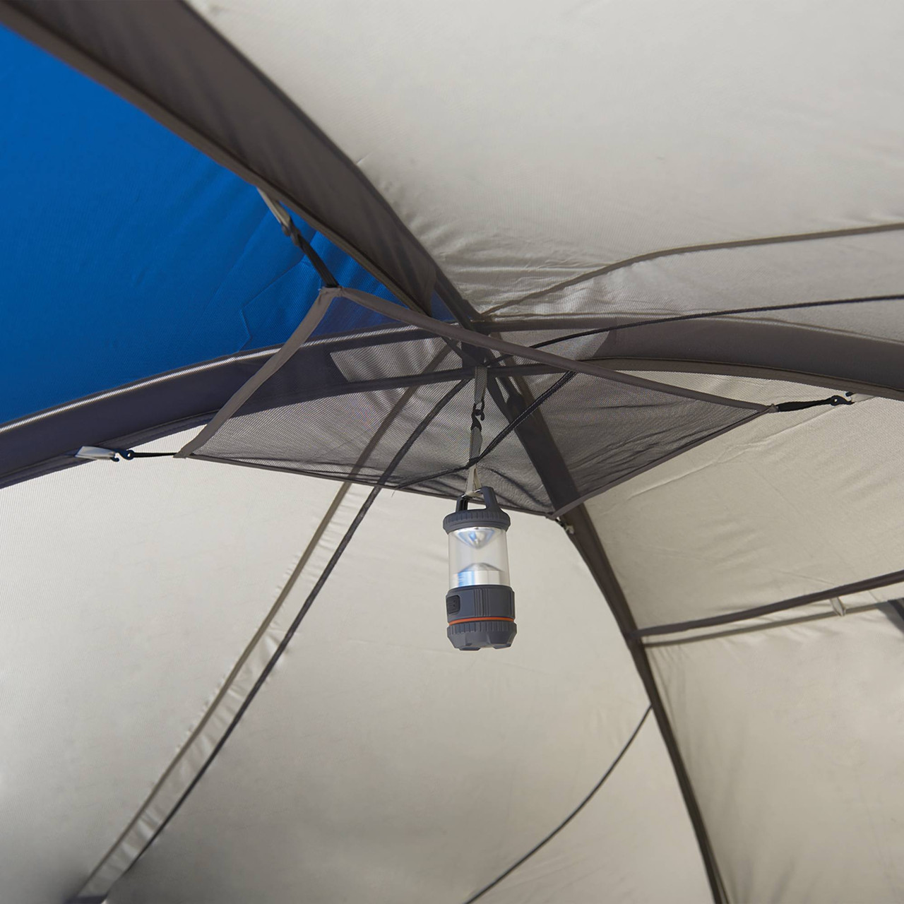 Interior of Wenzel Pinyon 10 Person Dome Tent, blue/white, showing lantern hanging from ceiling