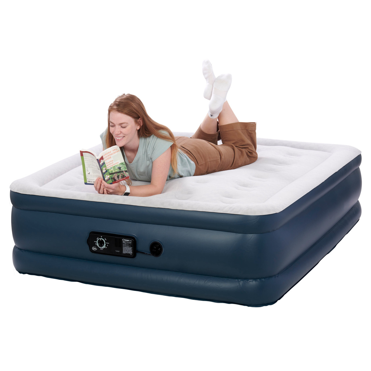 Woman reading a book on Serta 18" Raised Queen Airbed With NeverFlat Pump