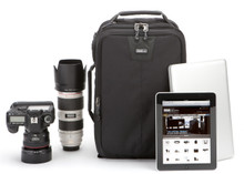 Airport Essentials camera backpack pictured with camera, lens, laptop, and tablet
