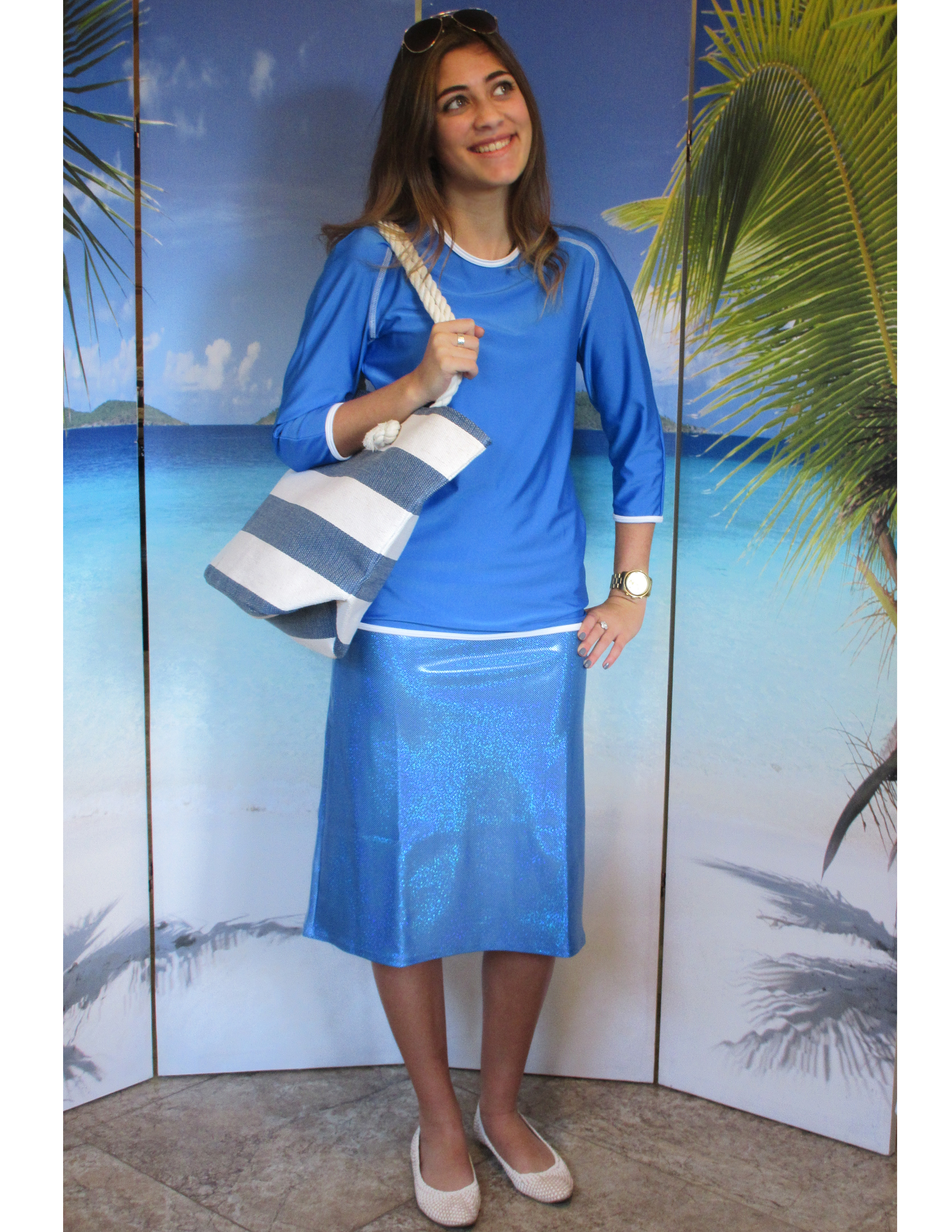 model-wearing-style-2629-in-sailing-blue-with-sparkle-blue-skirt-and-beach-bag.jpg