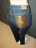 right view, 2 gold tone pockets located in rear with rocawear emblem on each side