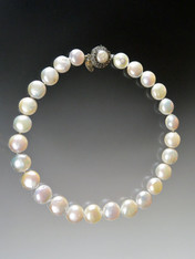 These grade AAA pearls are perfect for any occasion - a wedding, a birthday present, a graduation gift, or a night on the town.  They are huge (almost 16mm), not quite coin, not quite round but too uniform to be termed baroque.  The lustre is perfect. Hand-knotted in silk with a vintage mabe pearl sterling filigree clasp.  18"
