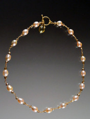 This is a stunning collectible necklace featuring opulent pink pearls and tiny cognac Swarovski crystals wrapped with gold wire and a 14K cast clasp and grade AAA topaz dangle to be worn in the front (or back if you prefer) Note: This clasp was is over 12 years old and is worth at least the cost of the necklace!  Very limited. 18"  