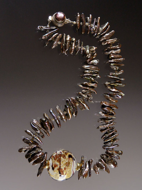 This opulent raw bronze biwa pearl collar spaced with tiny sparkling cognac Swarovski crystals features a dramatic 1-1/4" 24K Venetian glass disc framed with large 14K rondels.  Equally spectacular with a suit or an evening ensemble.  17"   