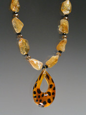 Want some animal magnetism? This gorgeous strand of freeform citrine nuggets features Swarovski crystal stations, a limited edition Venetian glass golden leopard pendant, and a citrine sterling clasp. 19-1/2" Pendant 2-1/4" x 1-1/2" 