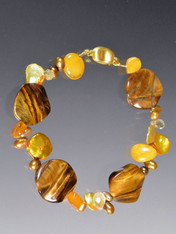 This bracelet features fluted tiger eye discs, yellow amber, gold pearls  - a perfect transition to fall. 7-1/2"