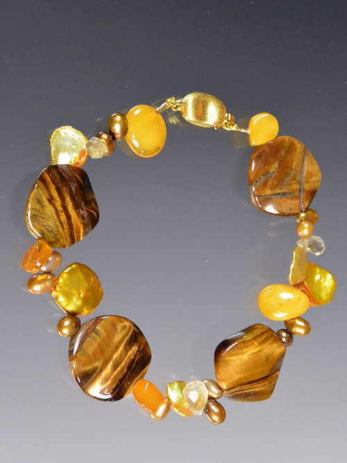 This bracelet features fluted tiger eye discs, yellow amber, gold pearls  - a perfect transition to fall. 7-1/2"