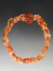 This beautiful necklace features multi-strand faceted carnelian with a carnelian donut and toggle clasp.  The matching bracelet with the same design can be fastened to make one long necklace.  20"