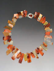 Beautiful shards of carnelian in every shade spaced with 14K rondels and a garnet sterling clasp make a beautiful asymmetrical collar for any occasion and any outfit. 18"