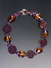You won't see anything like this anywhere!  It's my favorite in the entire collection.  This showstopper features glistening titanium coated Brazilian wine Druzy discs, step cut ruby rondels, and no longer available amber ruby Venetian sasso beads.  Plus a stunning Baltic Amber Silver  clasp 21"

