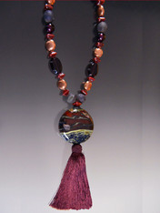 One of my three favorites in this entire collection (you can guess the other two).  Years ago a friend brought back from Venice the most unususal beads I've seen.  I made this spectacular huge wine toned one the focal point of this beautiful tassel necklace.  It features real copper large discs that mimic the shape of the focal bead, purple druzy, purple Venetian semi-transparent glass and Greek ceramic claret hexagons with a wine silk tassel.  Absolutely stunning. 24" tassel 6.5"

