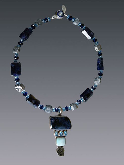 A truly spectacular statement piece, this dramatic necklace features step cut high quality iolite (from the sapphire family) spaced with pyrite nuggets and a large vintage iolite druzy blue topaz, miniature ammonite pendant.  18" Pendant 3"

