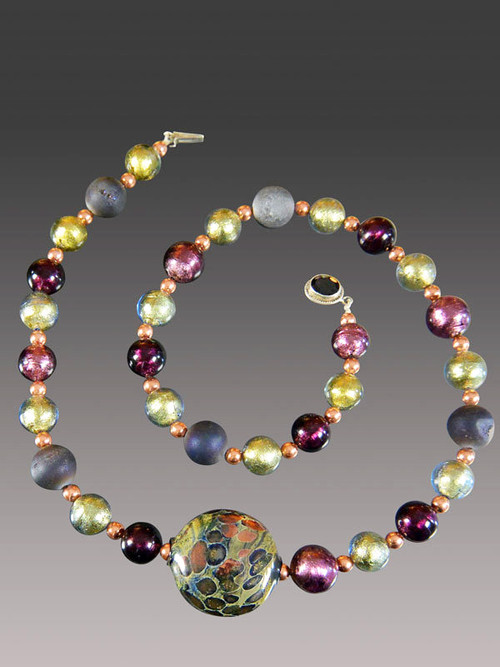 About 10 years ago a friend  on a trip to Venice brought me several extraordinary richly patterned Venetian beads in a a shape I've never seen again. This particular one of a kind bead features splashes of rich copper and is the highlight of a shorter version of my purple druzy Venetian amethyst olive copper rope with a garnet clasp..  Absolutely gorgeous and only one!  