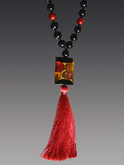 This statement on trend necklace is all you need to make any outfit stand out. The starting inspiration is an amazing limited edition Venetian arlecchino (or harlequin) rectangle in luscious dots of wine rubino and 24K Gold Foil paired with an red silk tassel and hand-knotted Venetian. Necklace 24" Silk Tassel 6.5""  There is only one artist in Venice who makes Arlecchino" beads and he has retired so there will not be any more of these coming.