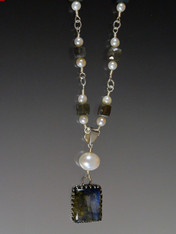 Part of our new young mix and match long and short delicate necklaces and chains, this beautiful design features a labradorite and pearl pendant on a long silver wire wrapped chain of grade AAA labradorite square beads and white freshwater pearls.  ONLY TWO.  28"

 