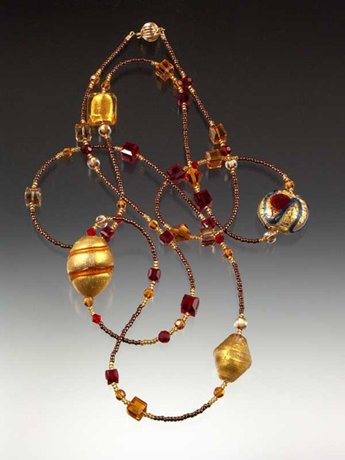 Razzle dazzle them in a rope of brilliant red, gold, and topaz Venetian glass, Swarovski crystals and Japanese seed beads.