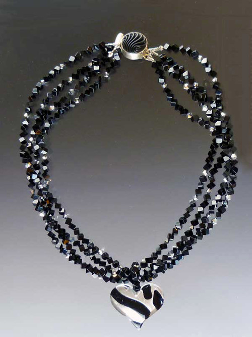 Two opulent looks in one! Luxuriate in four strands of Grade AAA onyx dice specially ordered for this design randomly spaced with sterling Swarovski crystals.  A dramatic Venetian glass freeform sterling black and silver tiger pattern heart suspended from a circle of onyx beads can be removed for an elegant torsade only look. ONLY TWO  18" (Longer lengths available on request)