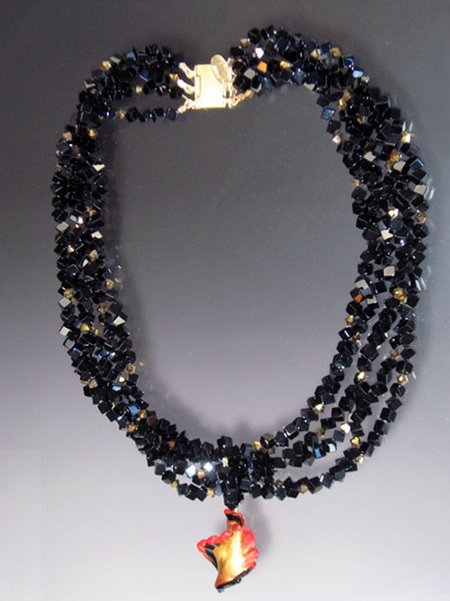 Luxuriate in six strands of Grade AAA onyx's dice spaced with 24K Swarovski crystals with 24K brushed goldplated clasp.  A dramatic Venetian glass swirl centerpiece suspended from a circle of onyx beads can be removed for an elegant torsade look. 18"
